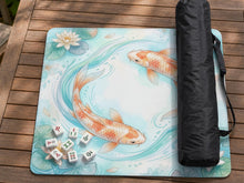 Pastel aqua square mahjong mat with orange koi fish, lotus flowers, lily pads, and flowing water lines.