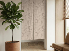 Beige door curtain with a crescent moon, leafy botanical branches, gray line art, and dotted celestial details.