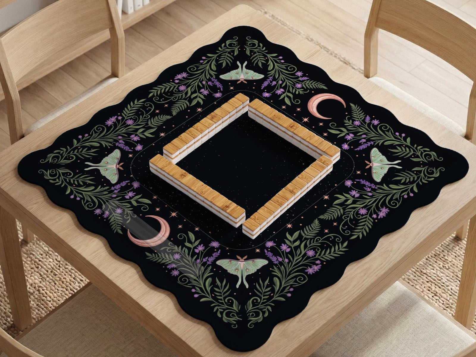 Black mahjong table mat with luna moths, purple flowers, soft green leaves, copper moons, and small star details.
