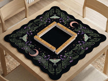 Black mahjong table mat with luna moths, purple flowers, soft green leaves, copper moons, and small star details.