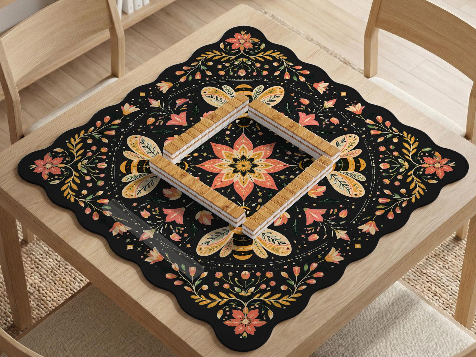 Black mahjong mat with a symmetrical botanical design, coral flowers, golden leaves, and small bees.