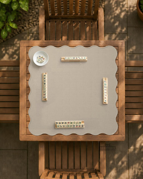 Beige square mahjong table mat with a scalloped edge shown on a plain background.