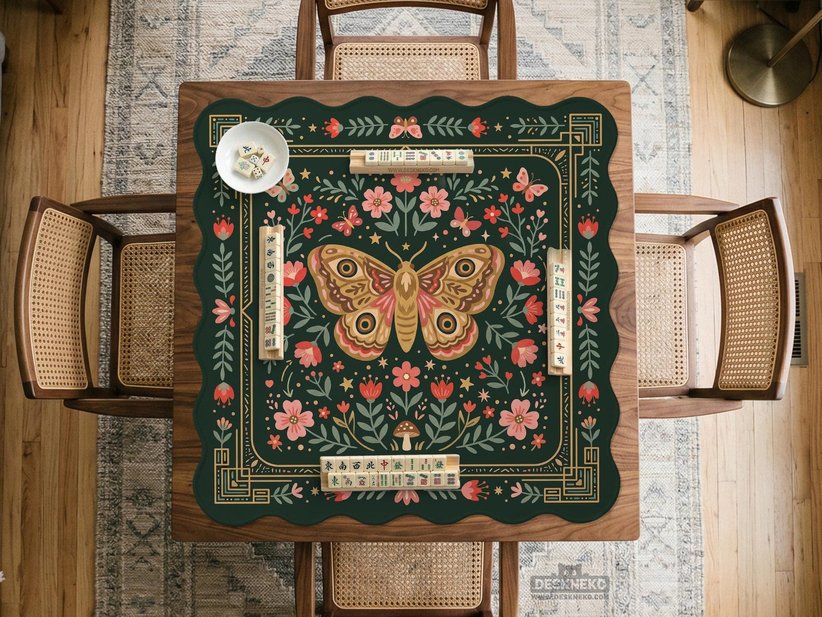 Dark green square mahjong mat with floral border artwork, moth illustrations, and gold line accents.