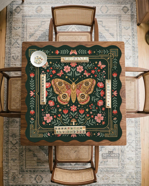 Dark green square mahjong mat with floral border artwork, moth illustrations, and gold line accents.
