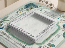 Mint green mahjong mat with peacock feather artwork, framed rule text around the edges, and a clear center play area.