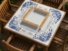 Blue and white mahjong mat with lucky cat illustrations, floral corner details, and a framed play area with printed guidance text.