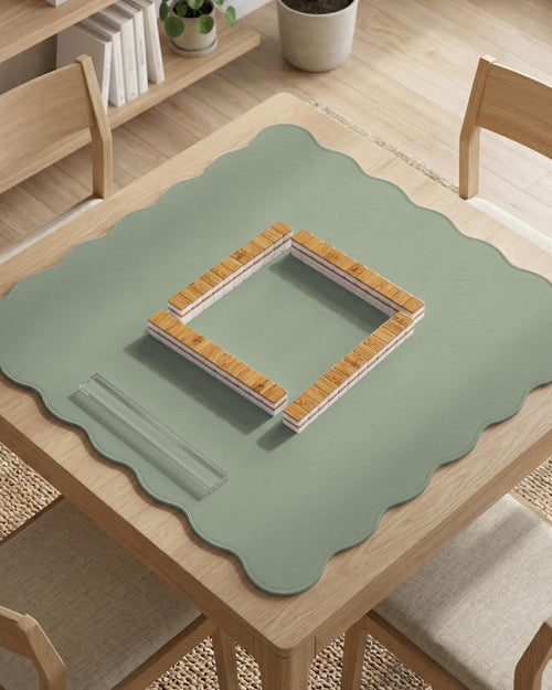 A plain light sage green square mahjong mat with a smooth solid-color surface.