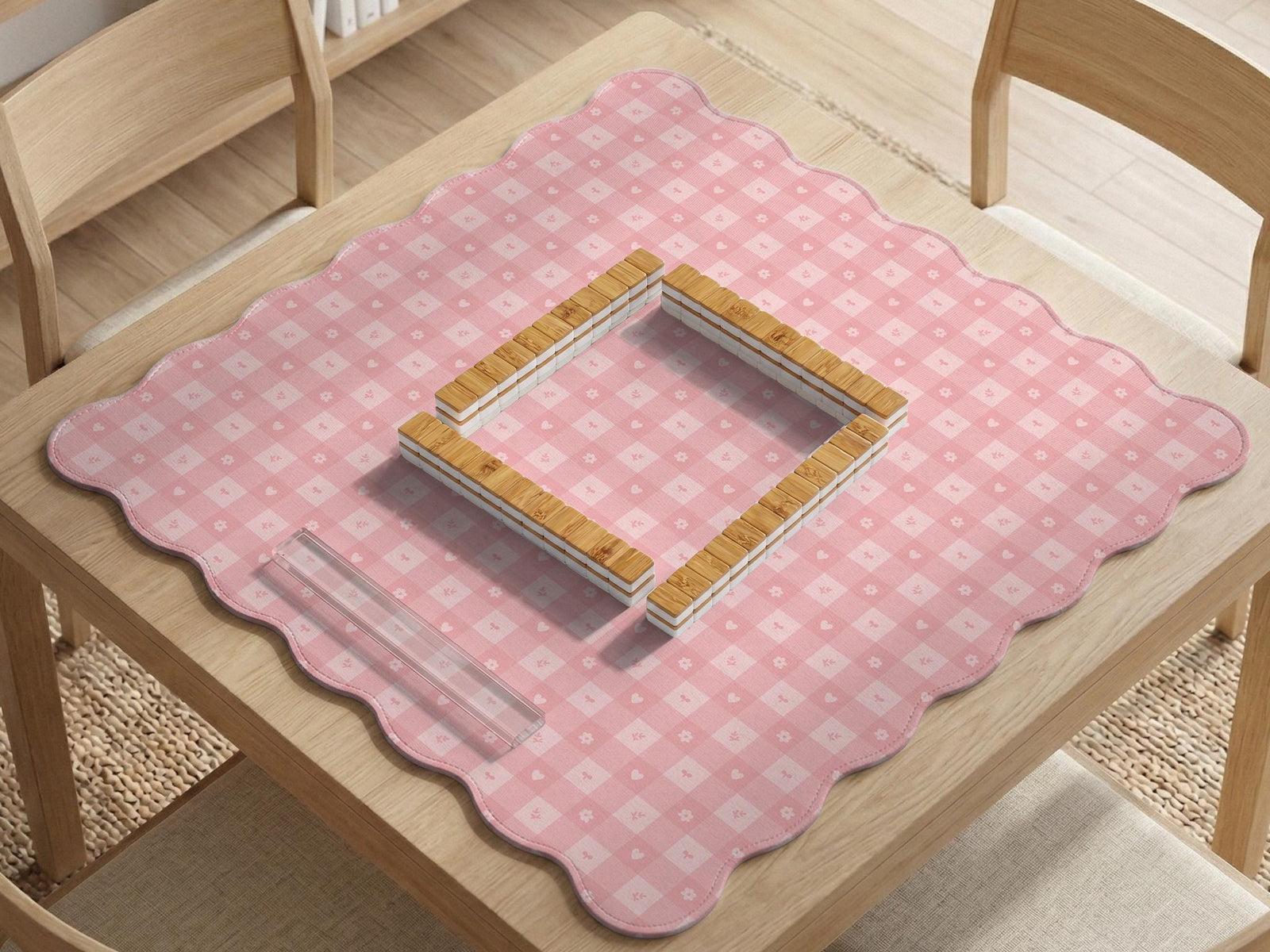 Pink scalloped square mahjong mat with a gingham check pattern, small flowers, and tiny heart details.