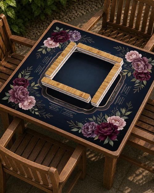 A burgundy floral mahjong mat with a peony border, blush pink and sage leaves, gold accents, and printed rules around an open center.