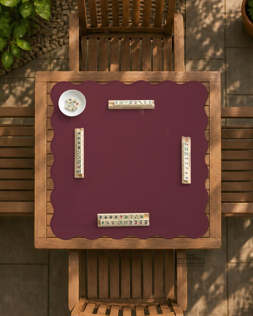 Plain burgundy square mahjong mat with scalloped edges on a white background.