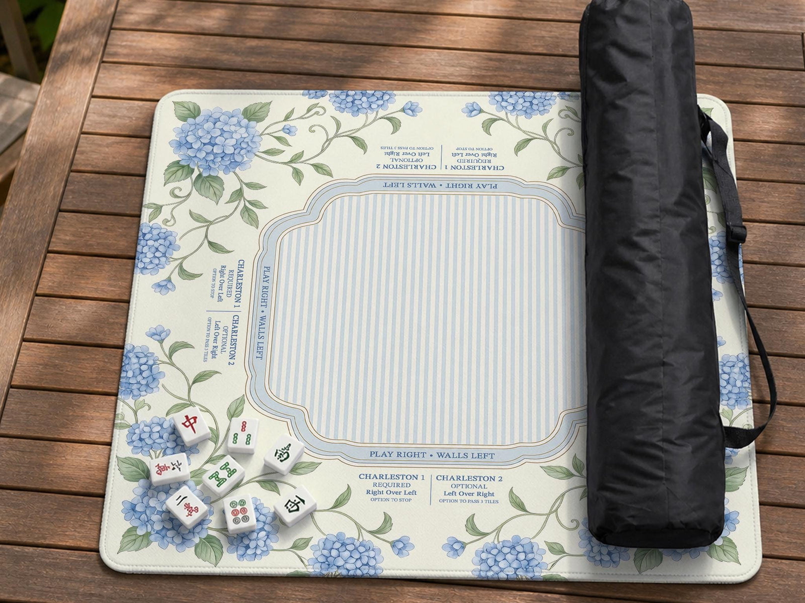 Blue hydrangea floral mahjong mat with a cream background, sage green vines, a striped center, and printed rule notes around the border.