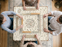 Cream square mahjong mat with a wildflower print, muted green stems, and small cottage-style flowers.