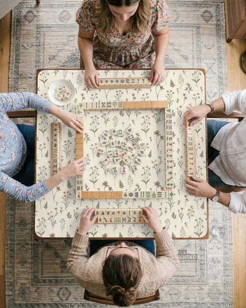 Cream square mahjong mat with a wildflower print, muted green stems, and small cottage-style flowers.