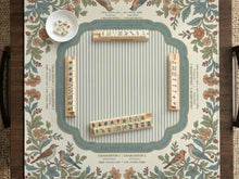 Square mahjong mat with a cream background, blue birds, sage leaves, terracotta flowers, and a decorative botanical border with printed rules text.