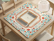 Cream square mahjong mat with a floral coral and teal botanical border and a blank center area.