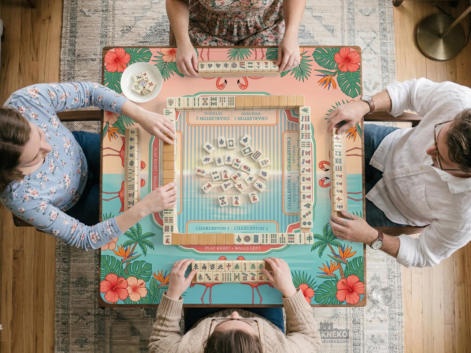 A square aqua mahjong mat with flamingos, palm leaves, and hibiscus flowers in a tropical pattern.