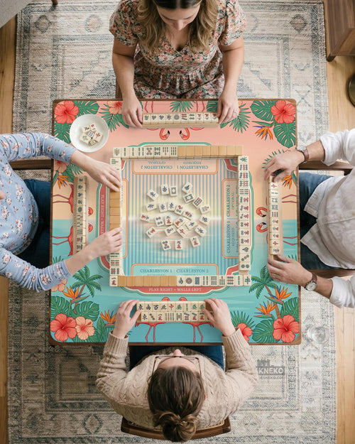 A square aqua mahjong mat with flamingos, palm leaves, and hibiscus flowers in a tropical pattern.