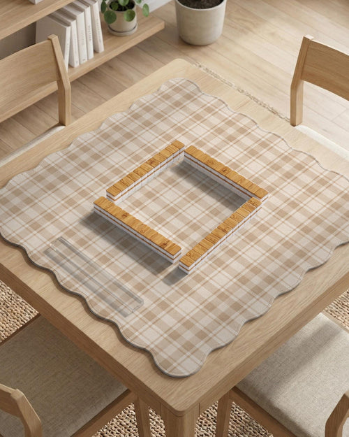 Beige plaid mahjong mat with a scalloped edge, shown as a square tabletop game mat in a cream and tan tartan pattern.