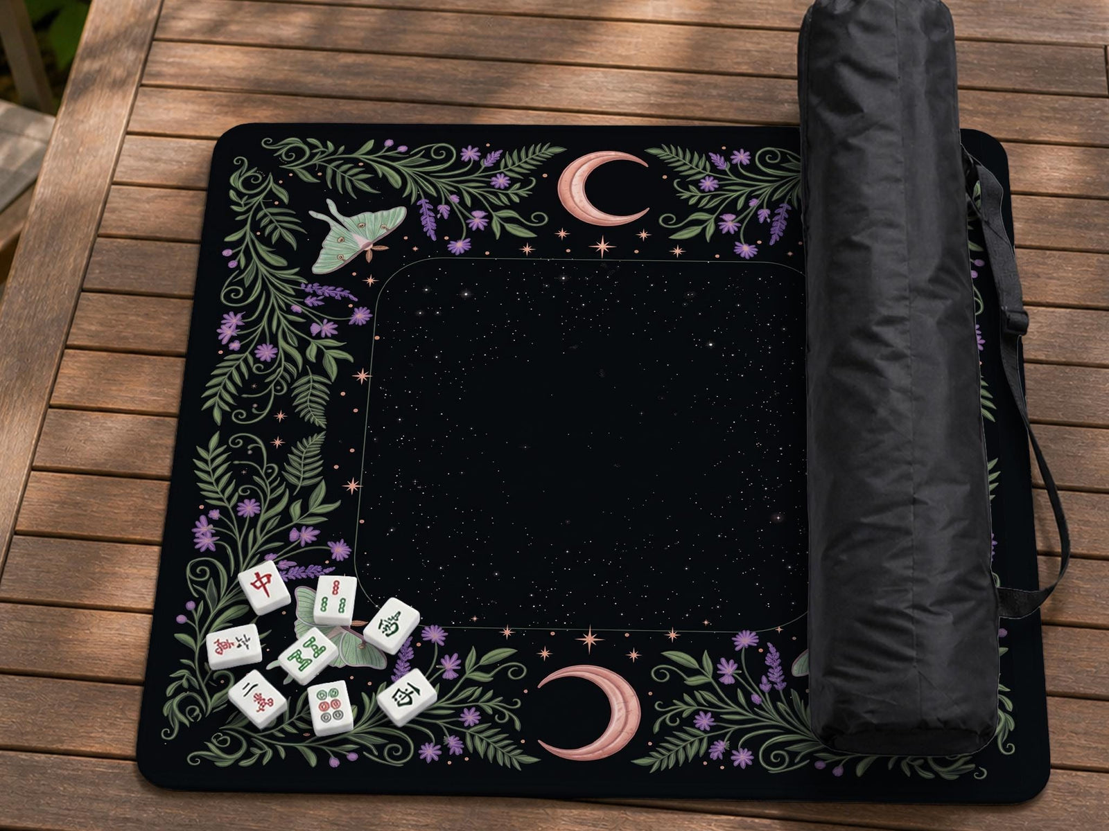 Black mahjong mat with luna moths, purple flowers, curling green vines, and a central play area with a purple border.