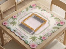 Pink mahjong mat with a scalloped edge design, palm leaves, hibiscus flowers, soft sage accents, and a striped center play area with printed rules around the border.
