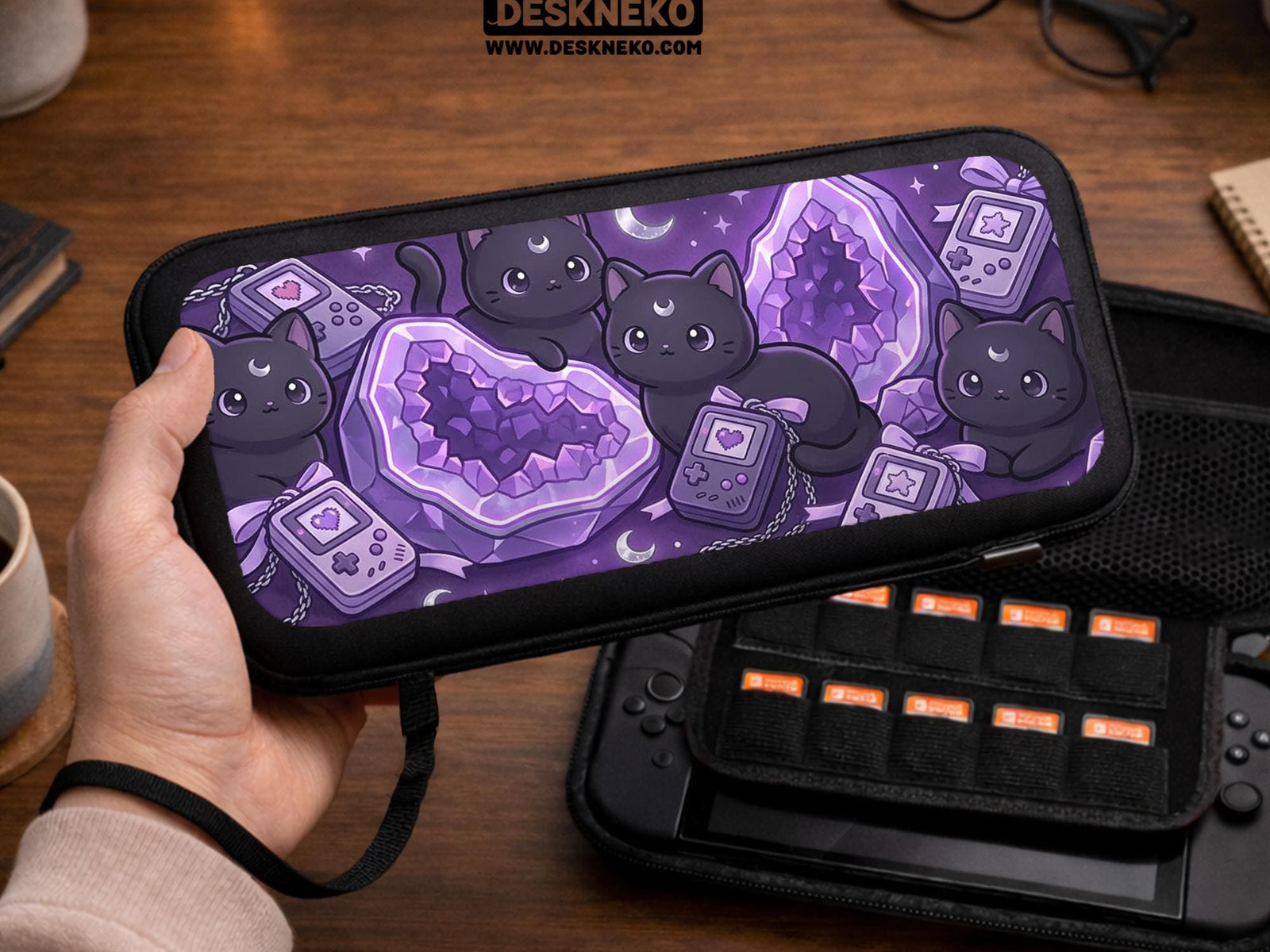 Purple carrying case with black cat faces, moon shapes, stars, and crystal geode style artwork for Nintendo Switch.
