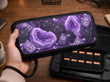 Purple carrying case with black cat faces, moon shapes, stars, and crystal geode style artwork for Nintendo Switch.