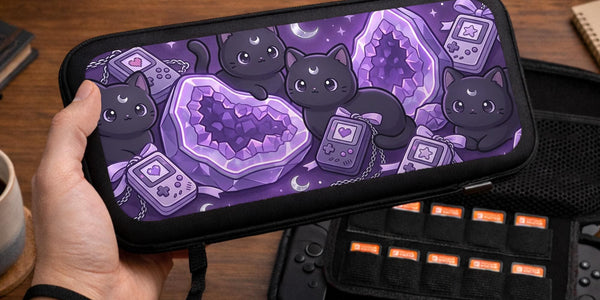 Purple carrying case with black cat faces, moon shapes, stars, and crystal geode style artwork for Nintendo Switch.