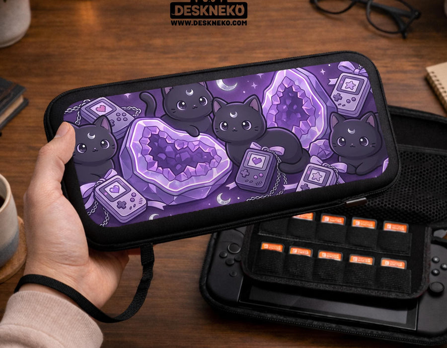 Purple carrying case with black cat faces, moon shapes, stars, and crystal geode style artwork for Nintendo Switch.