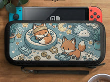 Pastel teal Switch travel case with orange fox characters, cream stars, clouds, hearts, and small gaming details.