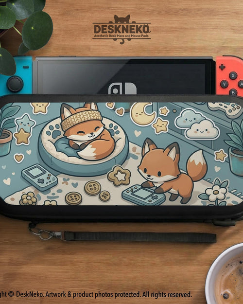 Pastel teal Switch travel case with orange fox characters, cream stars, clouds, hearts, and small gaming details.