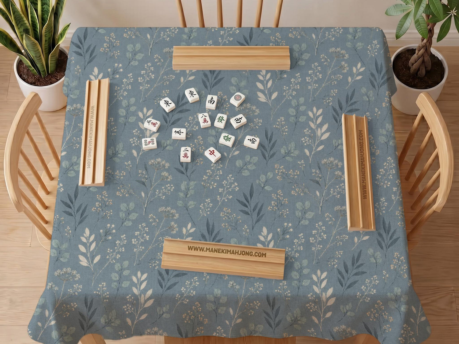 Blue mahjong mat with a dusty linen-look background and small leafy botanical stems in a floral pattern.