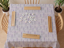 Lavender mahjong mat with a pale purple background, small botanical sprigs, and fine grid lines.