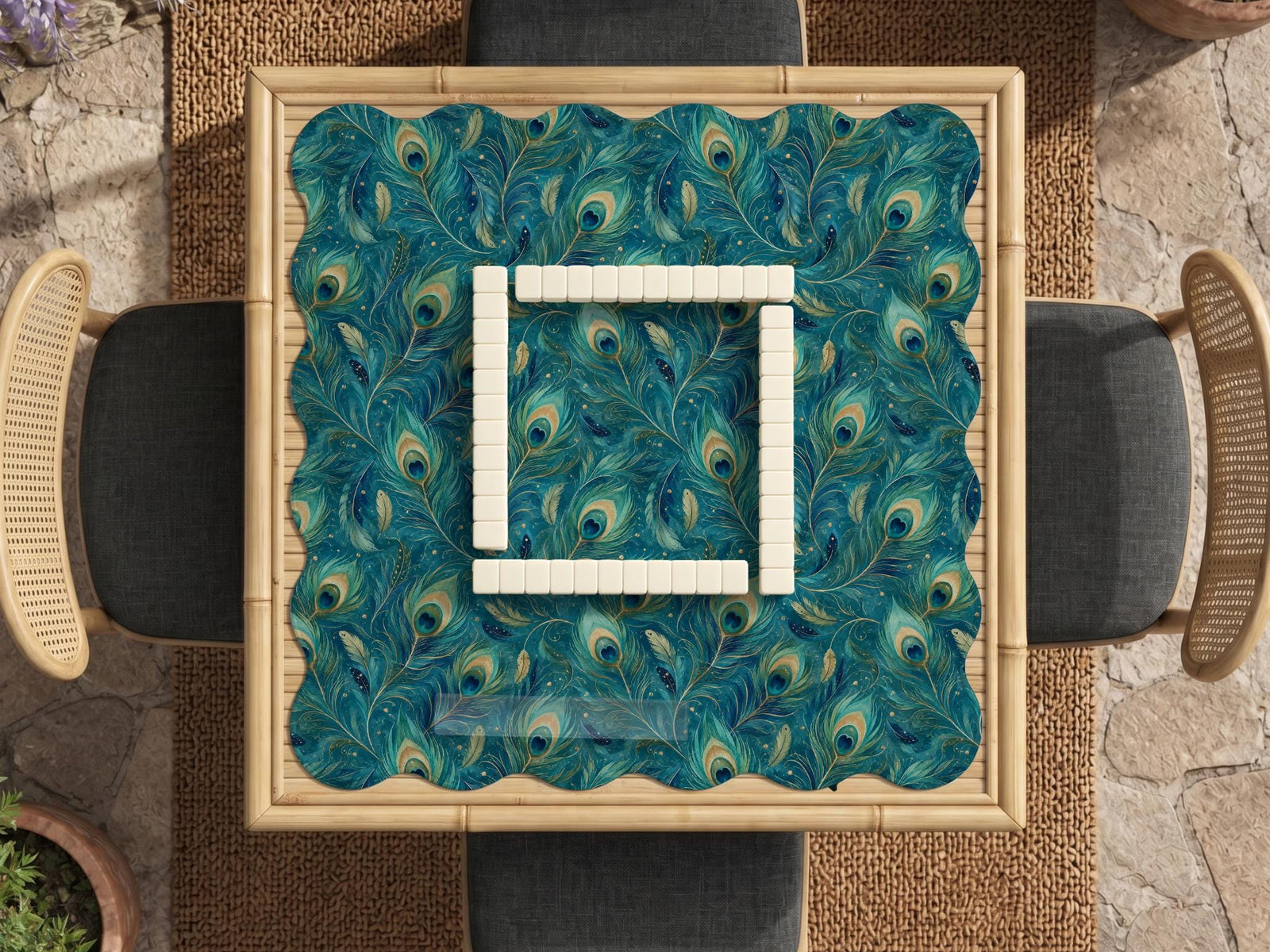 A teal mahjong mat with a peacock feather pattern and scalloped edges.