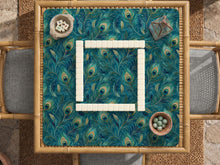 Teal mahjong mat with a peacock feather pattern in blue green tones.