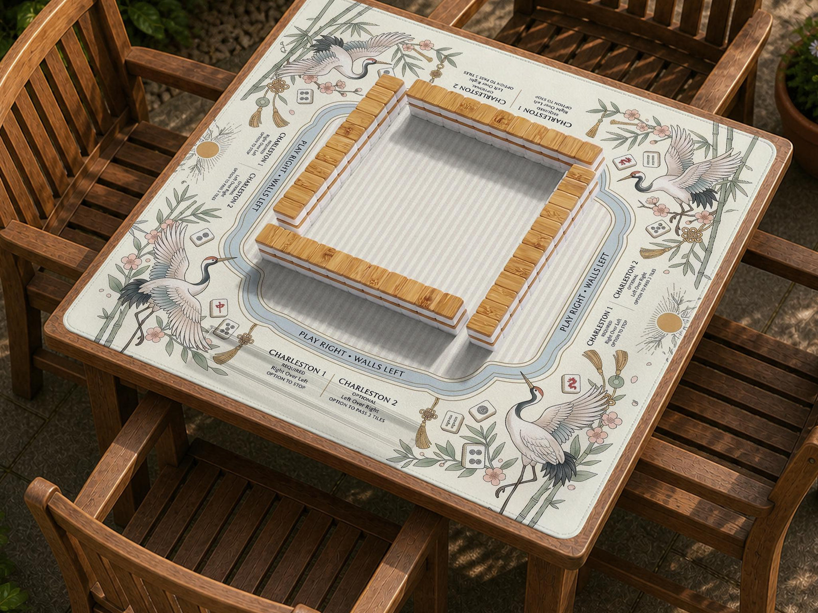Square sage and beige mahjong table mat with a crane bird design, bamboo accents, and printed rules and layout notes.