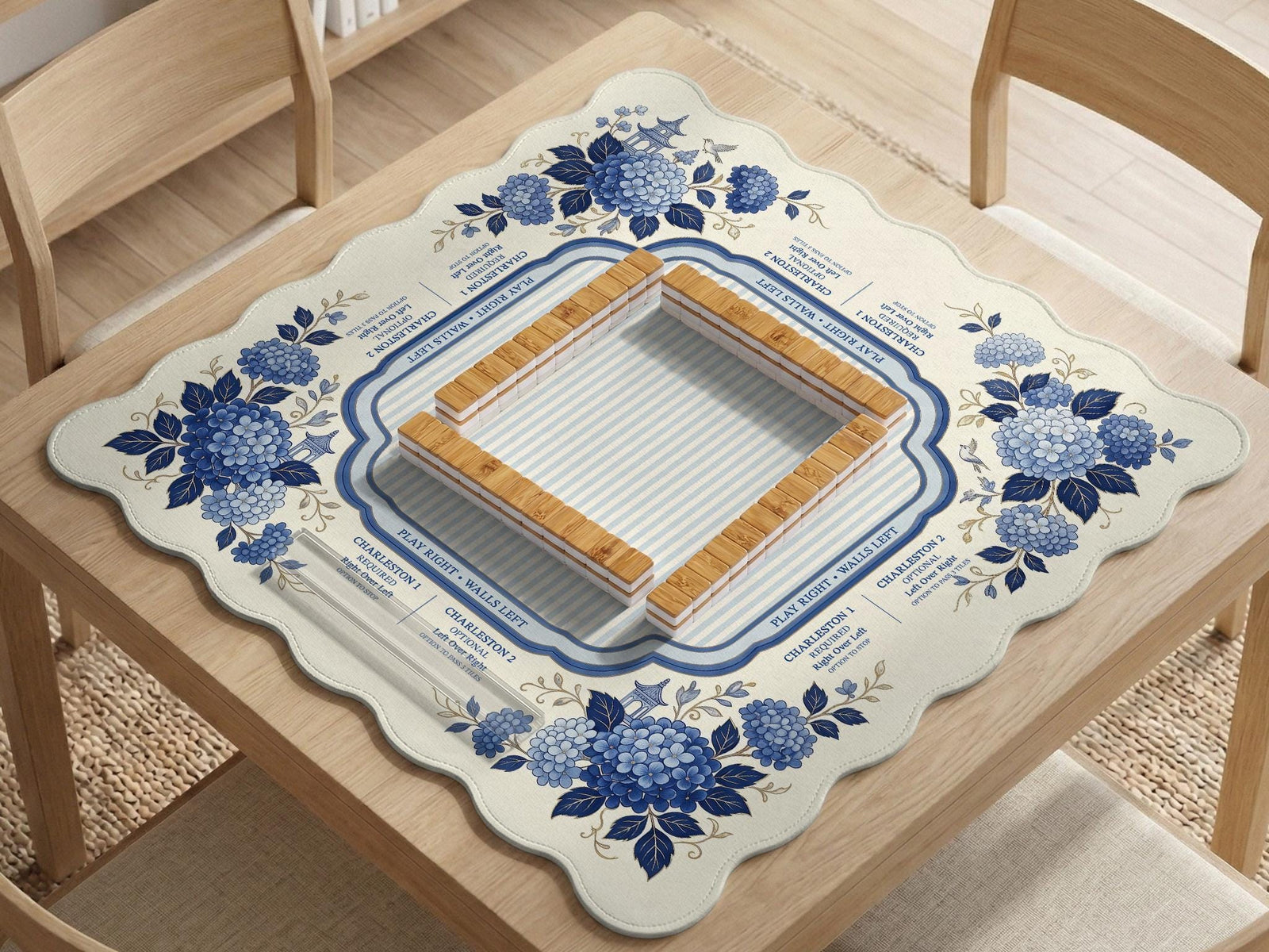 Blue and white mahjong table mat with a floral border, small birds, pagoda details, striped center, and printed rules around the edge.