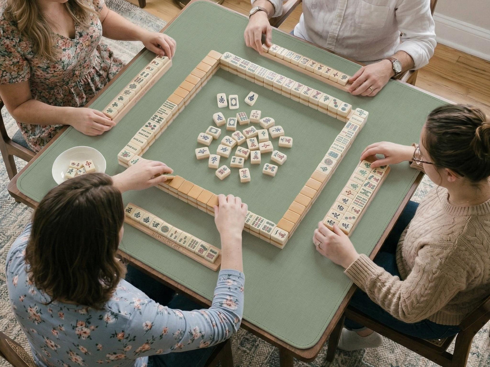 A square sage green mahjong mat shown as a plain green tabletop play surface.