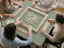 A square sage green mahjong mat shown as a plain green tabletop play surface.