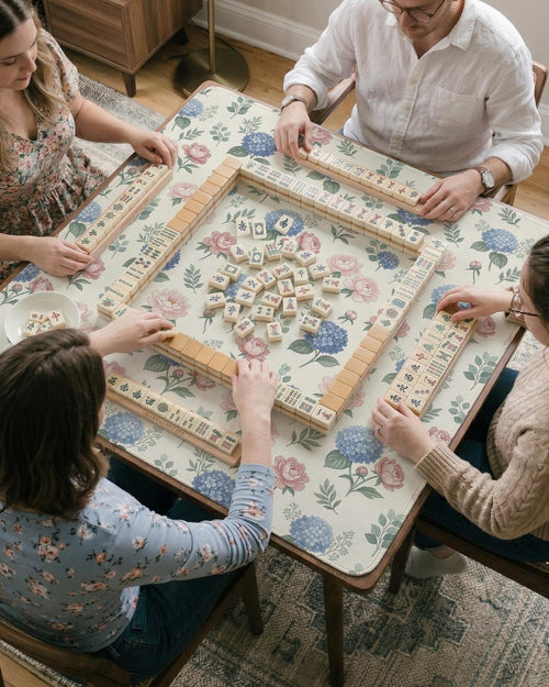 Blue mahjong mat with a peony and hydrangea floral pattern in soft blue, pink, ivory, and sage green.