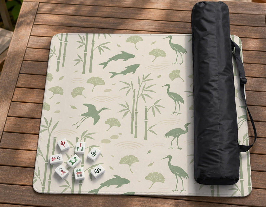 Cream mahjong mat with sage green koi, crane, ginkgo, and bamboo artwork in a repeating decorative layout.