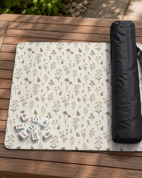 Cream square mahjong mat with a floral pattern of wildflower stems, sage leaves, and small blush blooms.