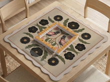 Beige mahjong mat with a botanical floral bird design, blush flowers, olive green leaves, black flower accents, and a warm linen-style background. Scalloped edge option shown.