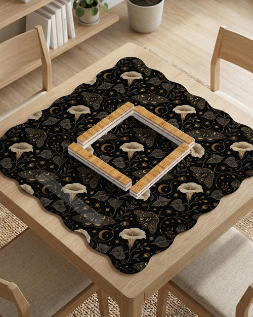Black scalloped mahjong mat with a moth and moonflower pattern, stars, and a decorative gothic-style design.