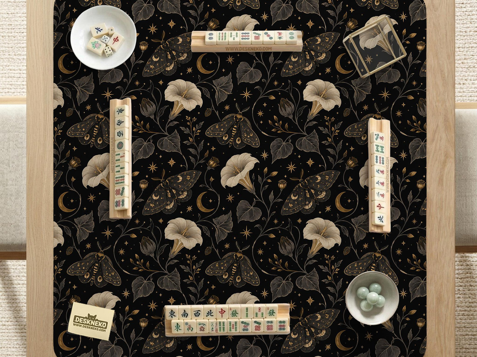 Black square mahjong mat with moths, moonflowers, crescent moons, and scattered stars in a celestial floral pattern.