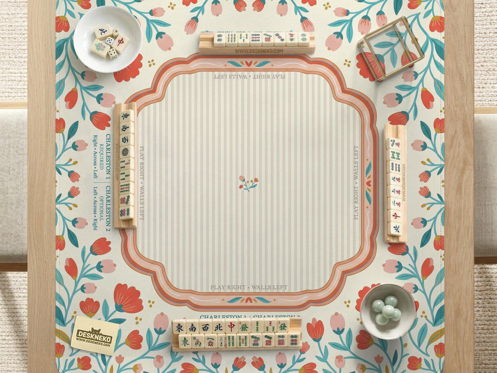 Cream mahjong mat with a coral and teal floral border, rule layout text, Charleston guide notes, and a blank center area for tile play.