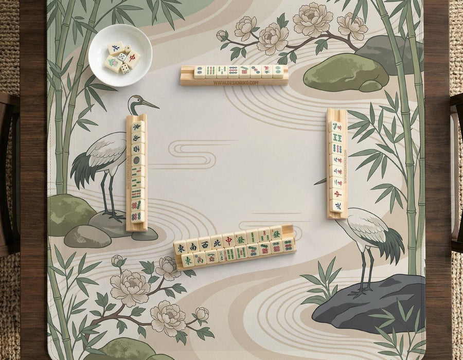 Square mahjong mat with a cream background, sage green cranes, bamboo leaves, peony branches, stones, and thin linework.