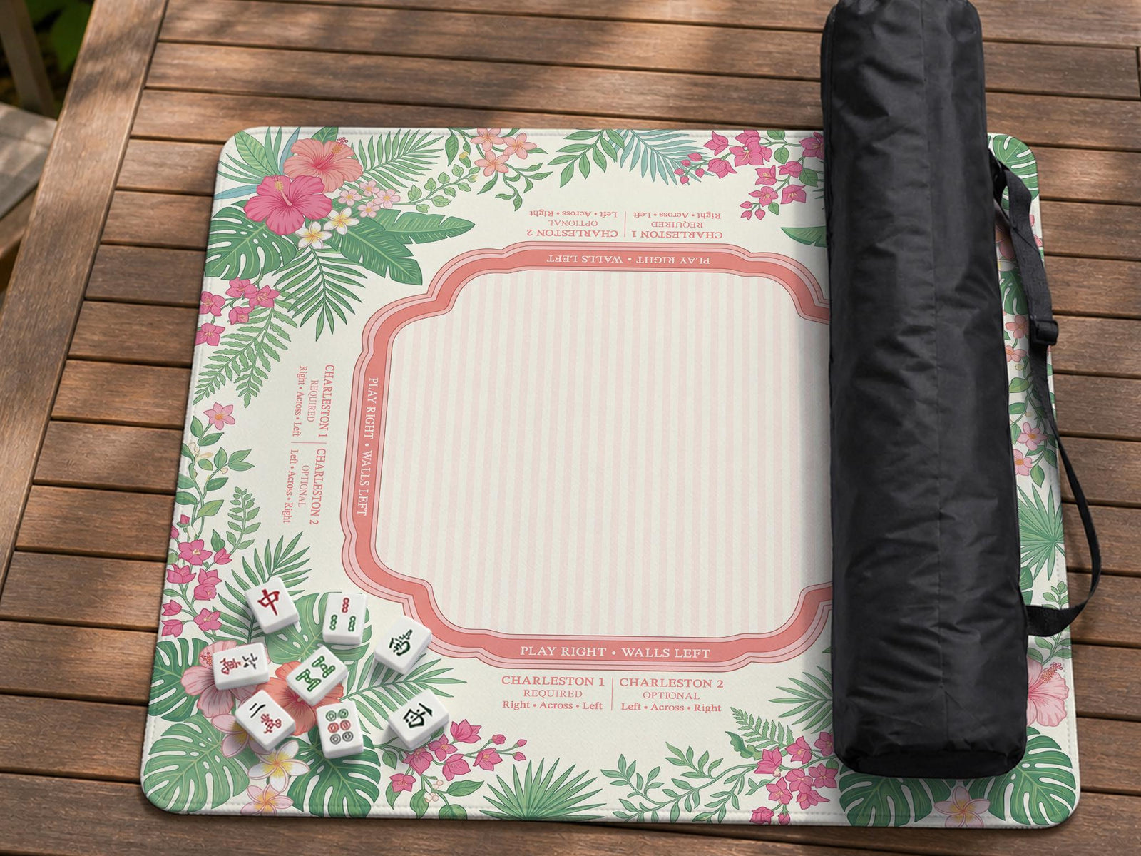 Coral pink mahjong mat with hibiscus flowers, palm leaves, cream rule boxes, and decorative tropical patterning.