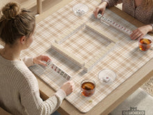 Beige plaid mahjong mat with a cream tartan pattern on a neutral background.