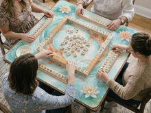 A soft blue mahjong mat with koi fish, floating lily pads, pale floral details, and a watercolor-style pond design.