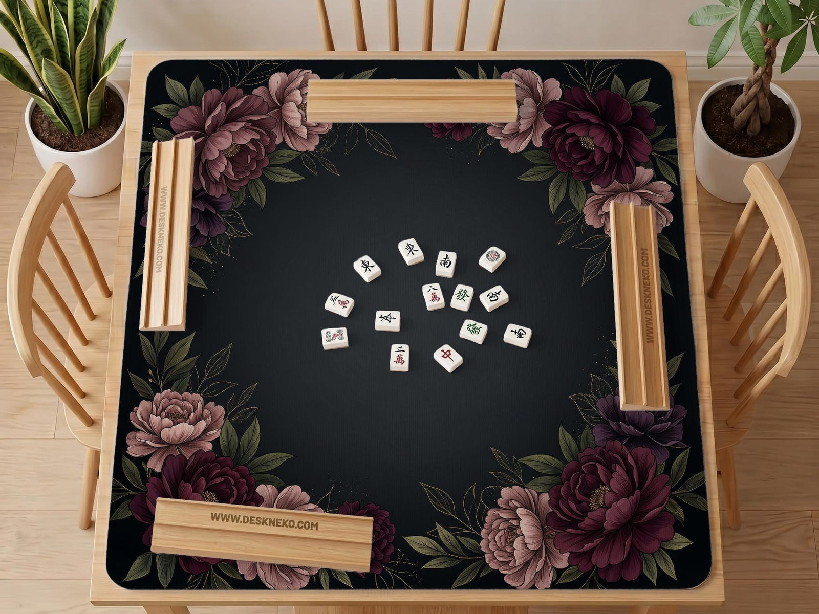 Black square mahjong mat with peony flowers in burgundy and soft pink, muted green leaves, and a blank center area.